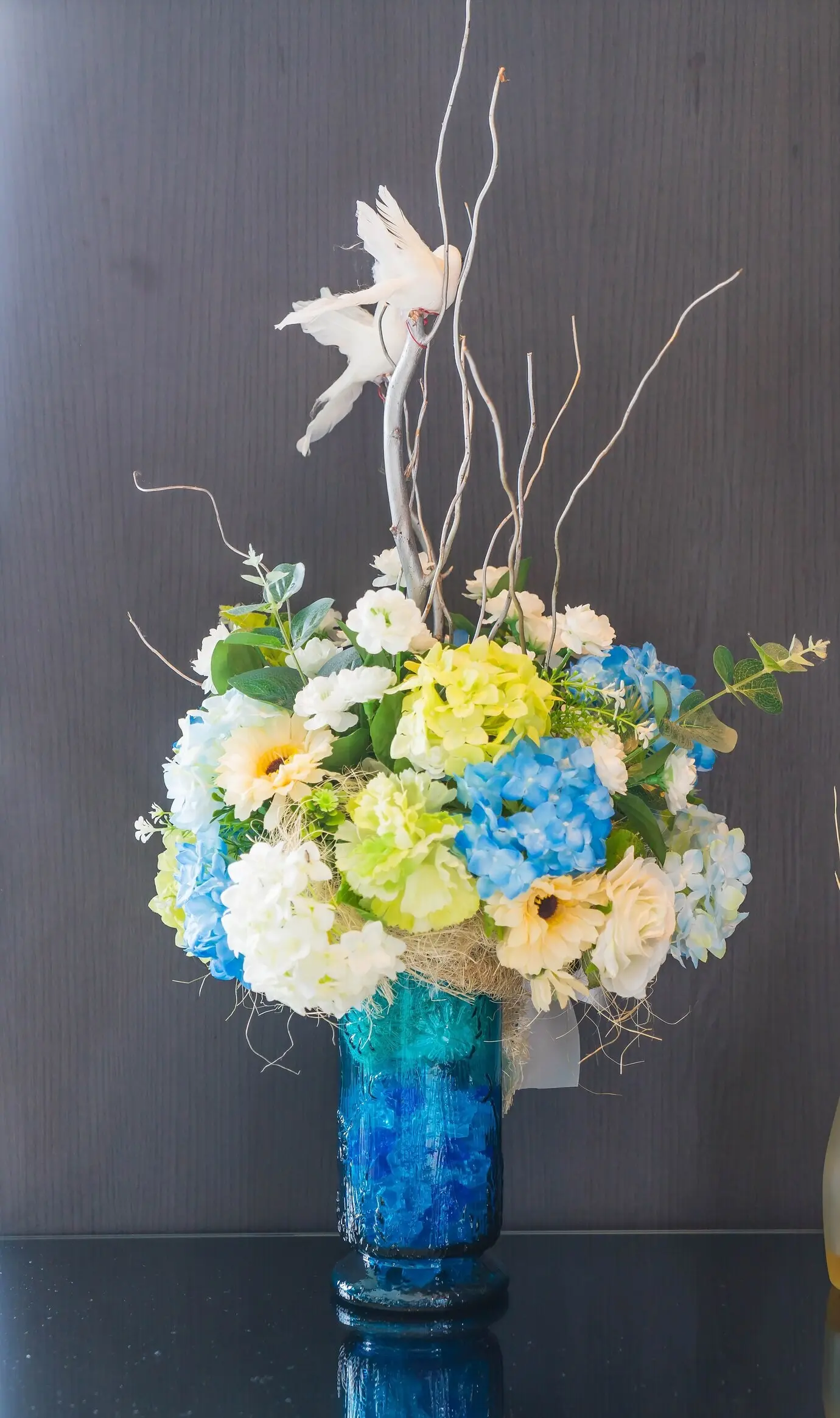 A bouquet of flowers in a pot as a decoration on the table.