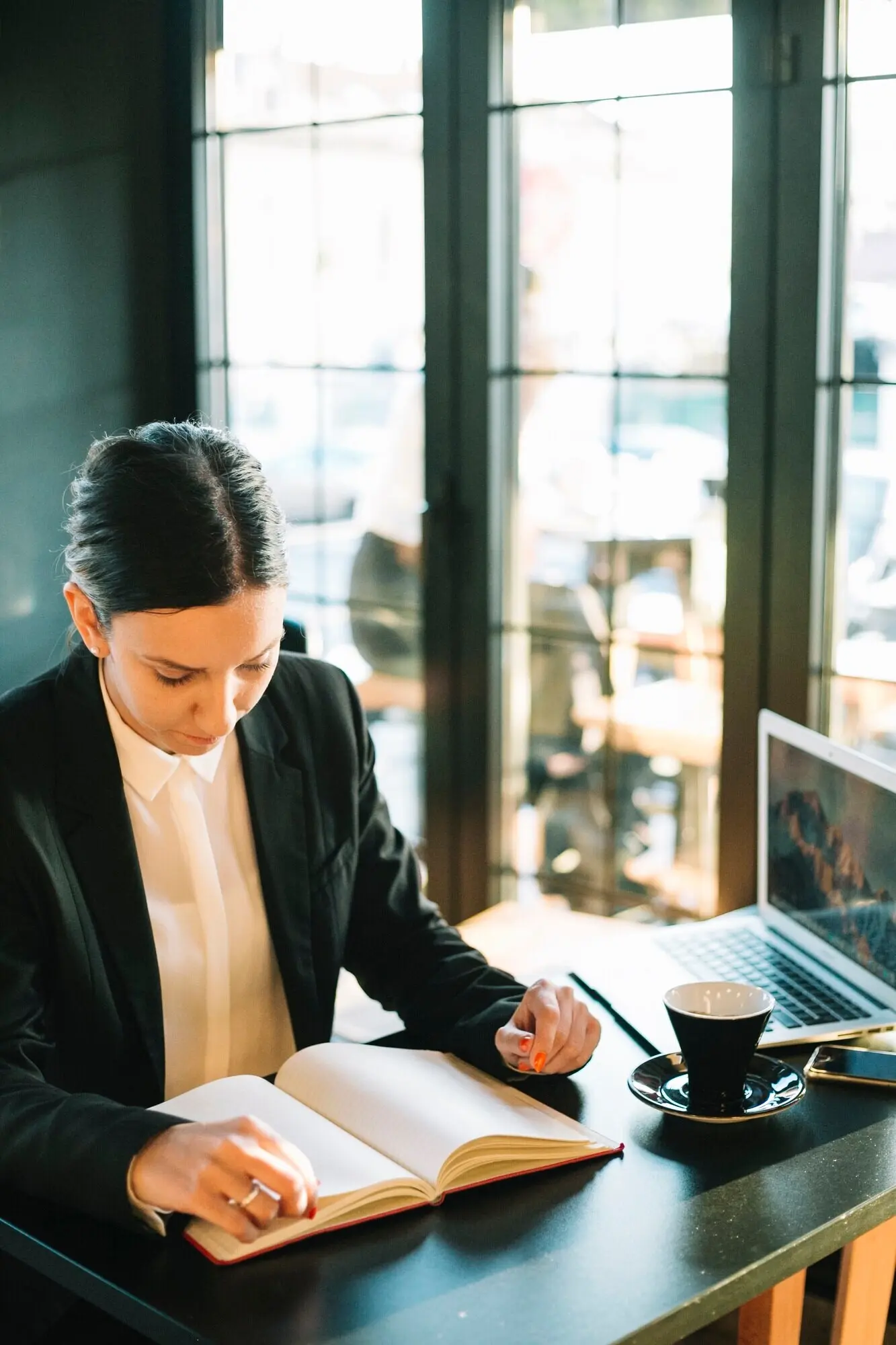 Businesswoman looking through a diary over a desk